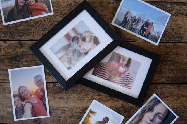 2 black frames showcasing 7x5 prints